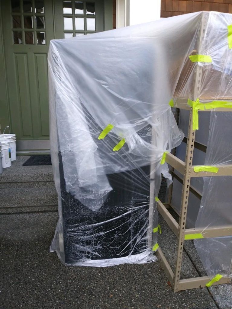 Appliances outside and tarped against the weather